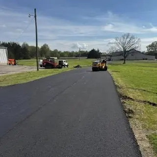 Paved driveway bordered by grass