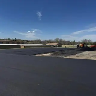 Open asphalt area under a clear blue sky